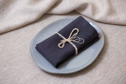 Slate grey organic linen napkins with mitered corners. Sustainable, reusable, and perfect for dinner, lunch, or cocktails. Wholesales, bulk custom order.