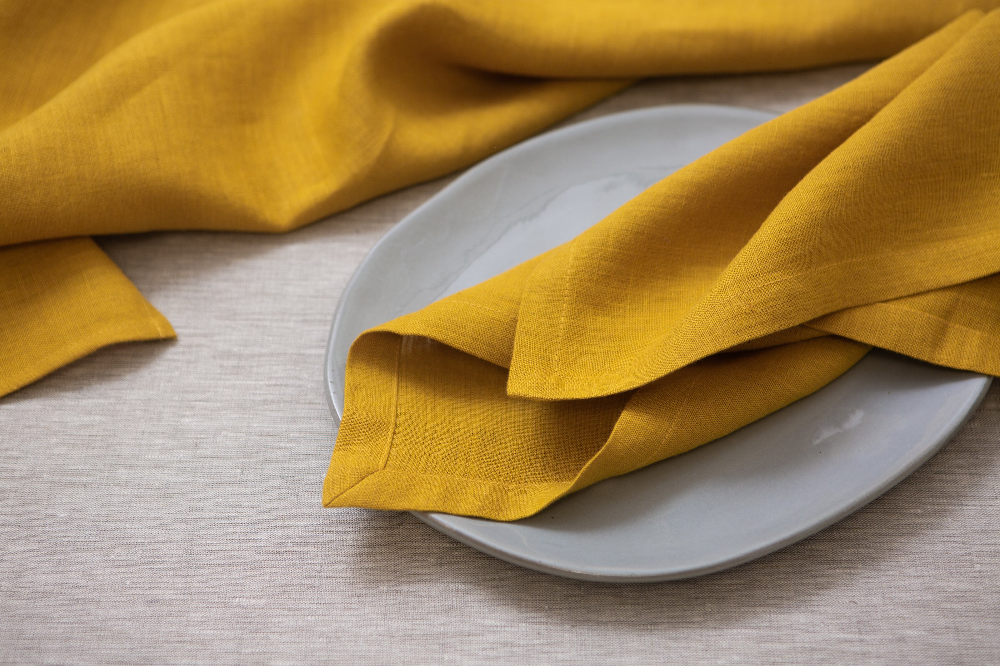 Mustard yellow organic linen napkins – eco-friendly, durable, and perfect for bringing a pop of color to your table while being sustainable.