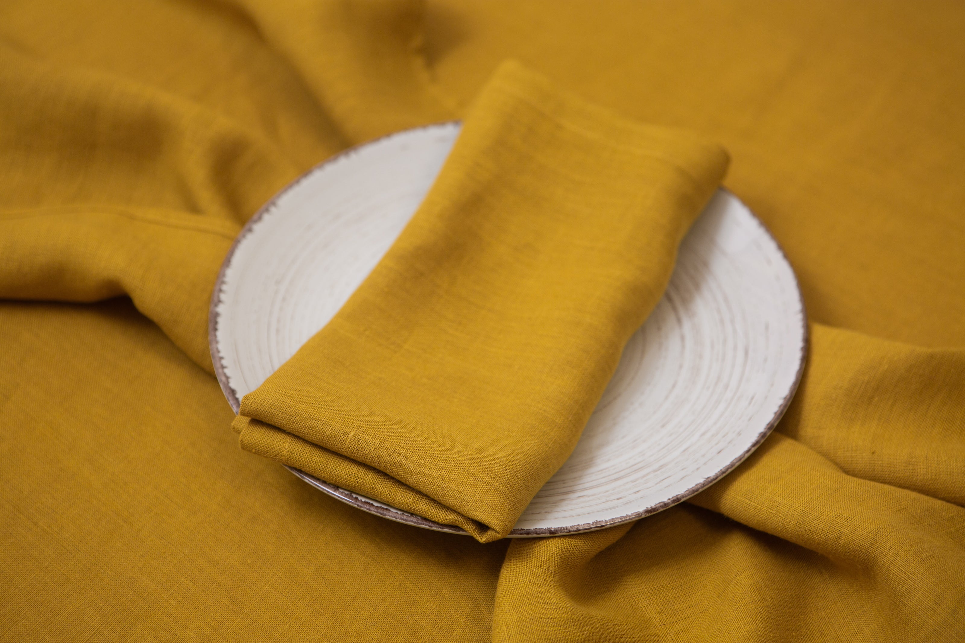 Mustard organic linen napkins with mitered corners – a stylish and eco-friendly gift idea for the holidays, perfect for adding a sustainable touch to your table settings.