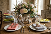 Elegant Easter brunch table with organic linen napkins, ceramic bunny decor and fresh spring flower centerpiece