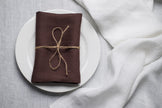 Cacao brown stonewashed linen napkin on a plate – fall and Halloween table decor