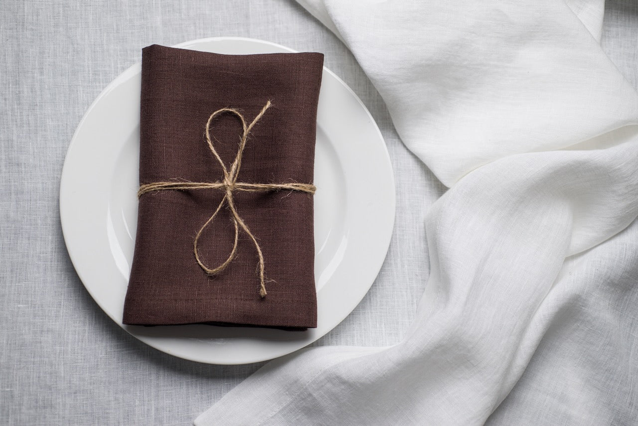 Cacao brown stonewashed linen napkin on a plate – fall and Halloween table decor