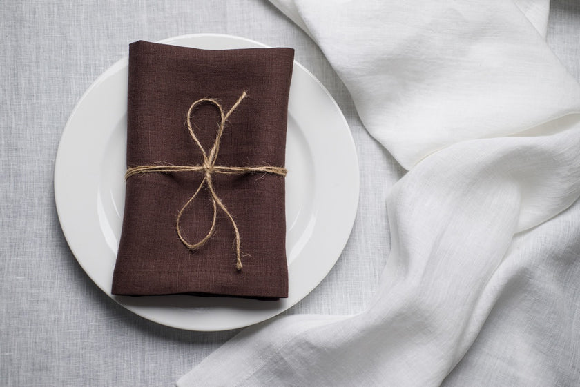 Cacao brown stonewashed linen napkin on a plate – fall and Halloween table decor