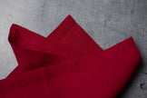 Folded wine red linen napkins on concrete – stonewashed linen texture