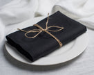Black cloth linen napkin with clean edges, minimalist table setting decor, sustainable reusable napkin for modern dining
