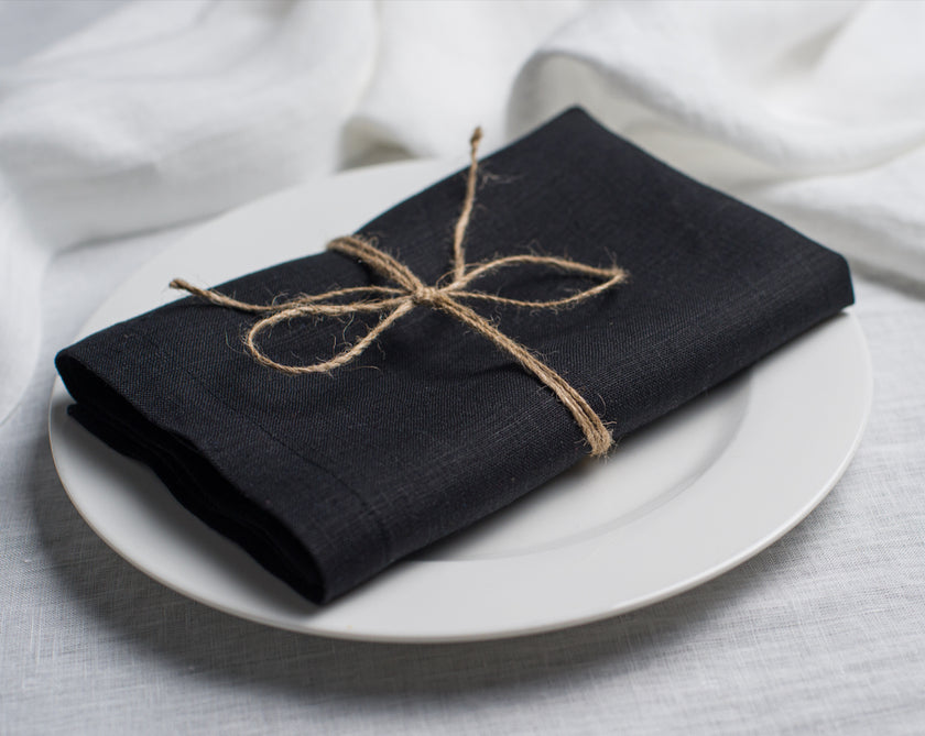Black cloth linen napkin with clean edges, minimalist table setting decor, sustainable reusable napkin for modern dining