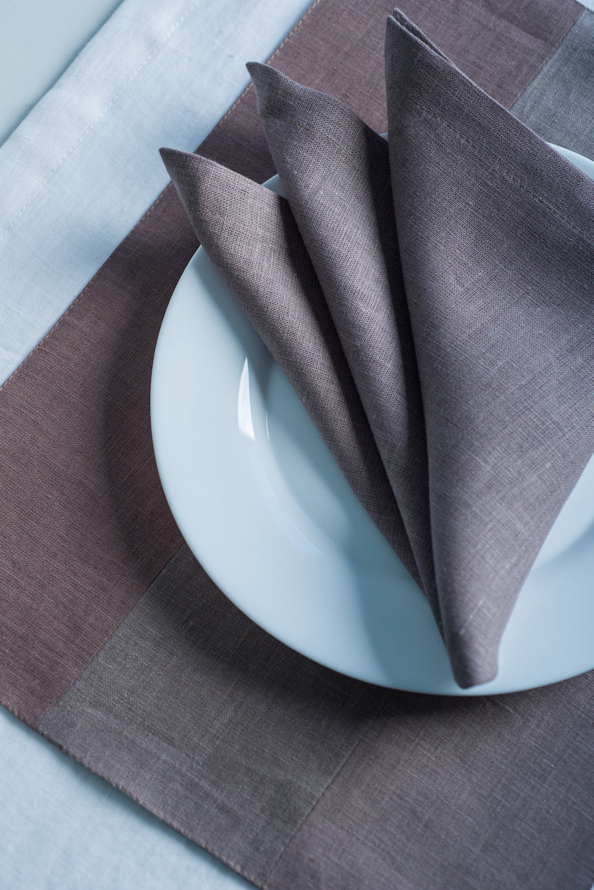 Limed oak and fog shade linen placemats made from natural flax, zero-waste table linens for eco-friendly table styling.