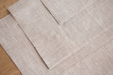 Close-up of a natural linen tablecloth mitered corner