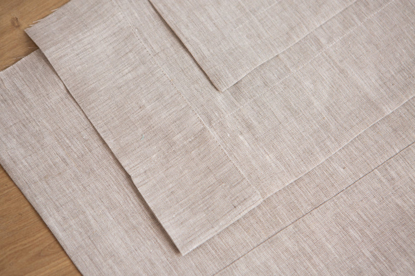 Close-up of a natural linen tablecloth mitered corner