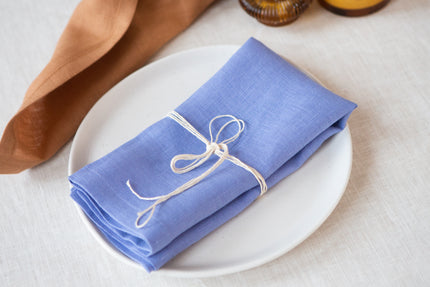 Cornflower blue organic linen napkins with mitered corners. Elegant, sustainable, and perfect for any dining occasion.