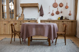 Limed oak linen tablecloth on a dining table in a cozy rustic kitchen