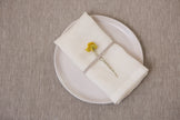 Pure white organic linen napkins with mitered corners. Zero-waste, sustainable, and ideal for weddings, holidays, or everyday dining.