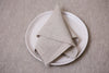 Classic beige linen napkins crafted from eco-friendly organic fabric. A sustainable touch for every table setting.