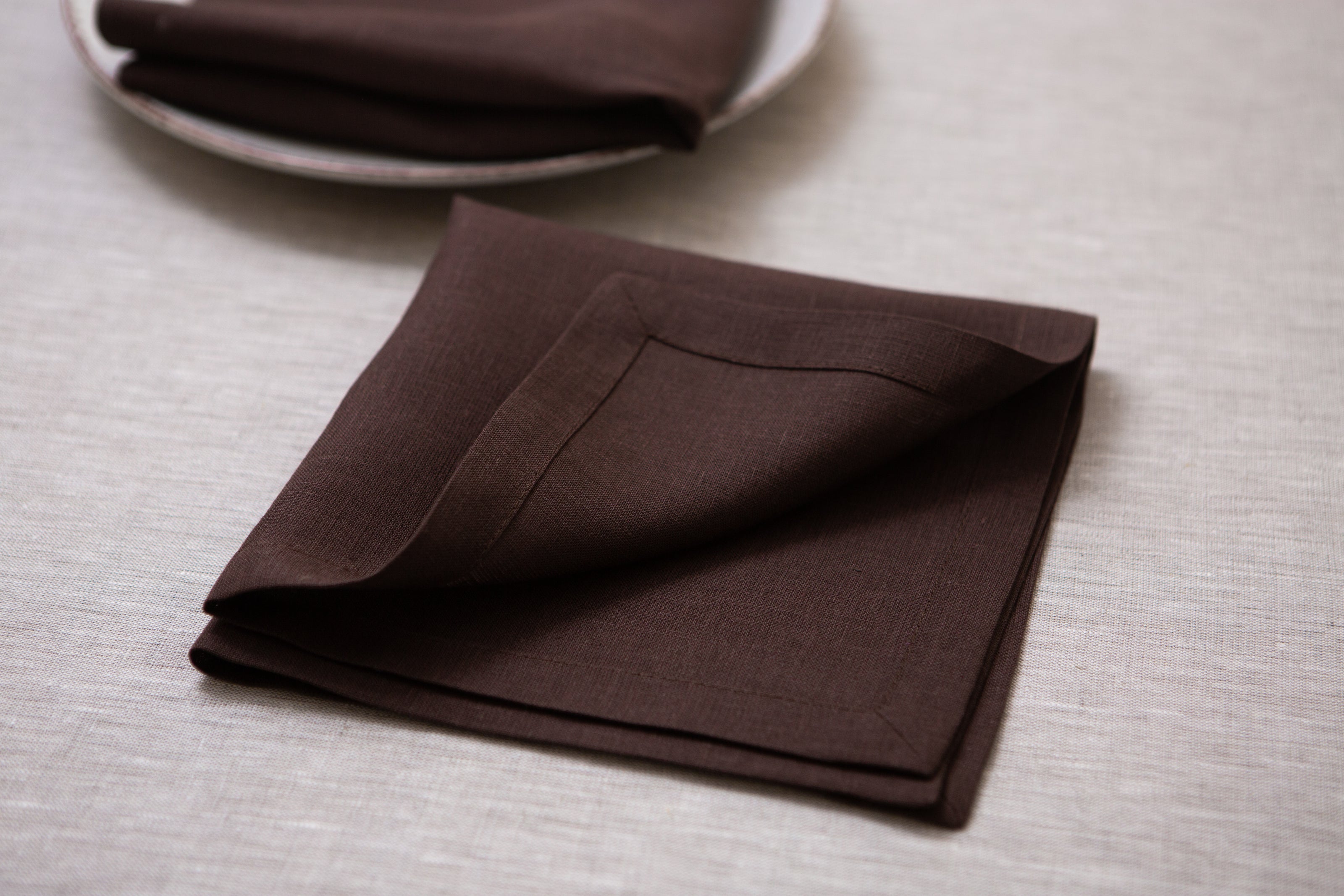 Rich cacao linen napkins with mitered corners – an eco-conscious choice for eco-friendly homes, dinner parties, and special celebrations.