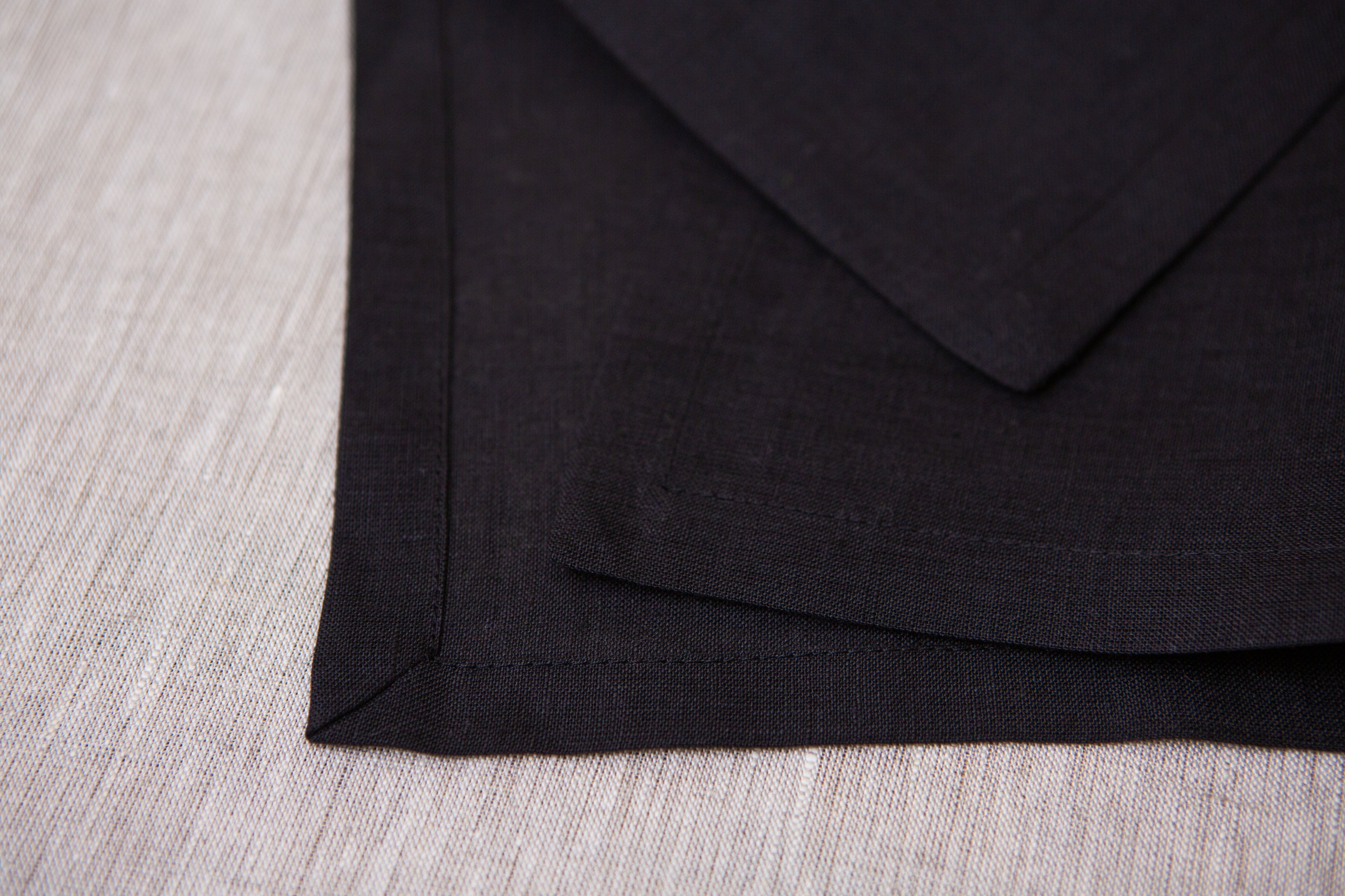 Eco-friendly black organic napkins: reusable, washable, and ideal for home table decor.