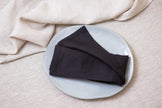 Elegant black organic linen napkins with mitered corners. Sustainable, reusable, and perfect for lunch, dinner, or cocktails.