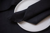 Sustainable black linen napkins with mitered corners. Perfect for lunch, dinner, or cocktail settings.