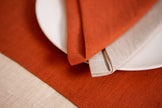 Terracotta linen placemat in a warm harvest table setting