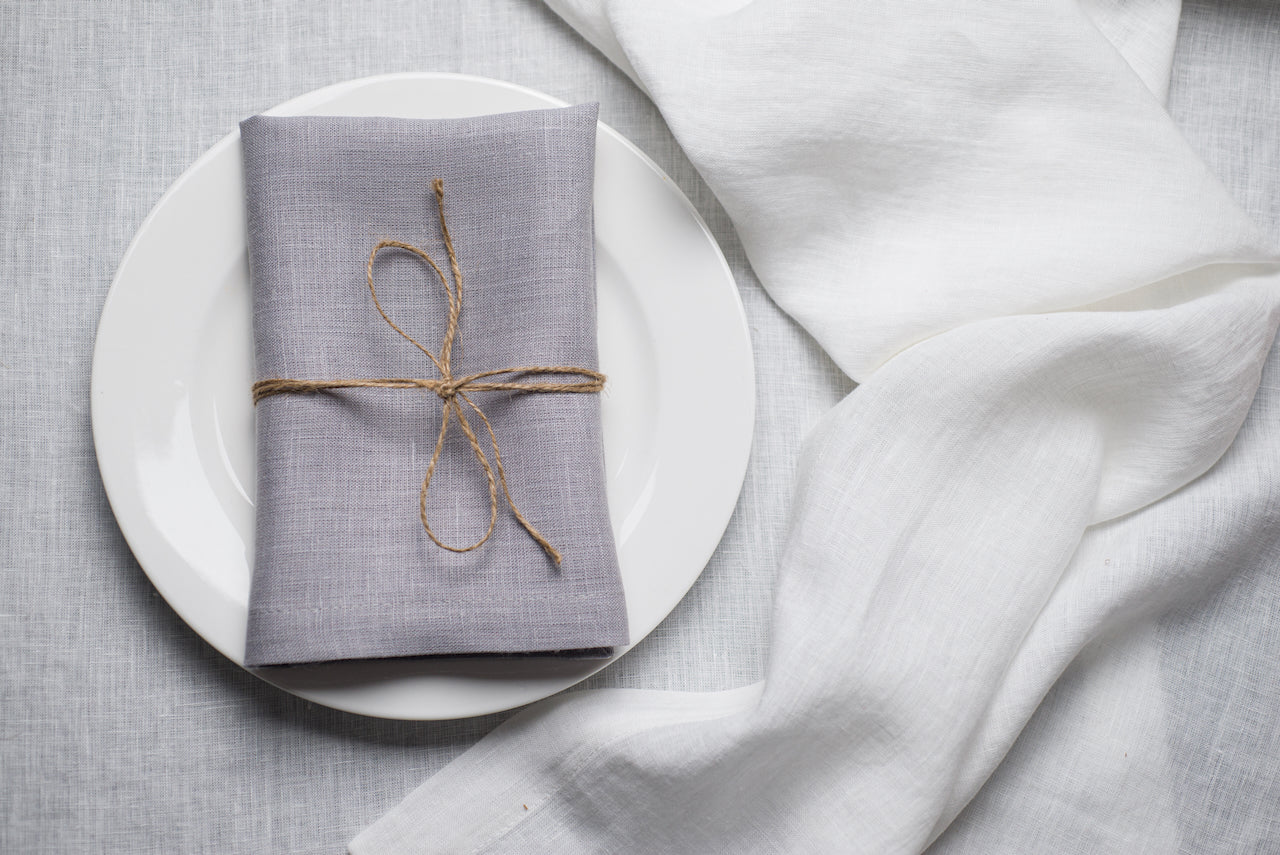 Light grey organic linen napkin arranged for a refined Easter table setting. The subtle neutral shade balances pastel florals and white ceramics for modern spring decor. Crafted from eco-friendly natural linen for sophisticated and sustainable entertaining.