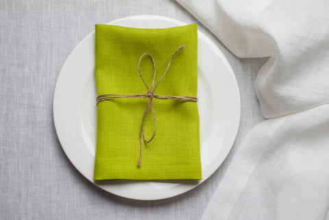 Easter lime green organic linen napkin arranged on a light spring table setting. The vibrant green tone brings energy and freshness to Easter dinner decor. Crafted from sustainable natural linen for elegant holiday hosting.