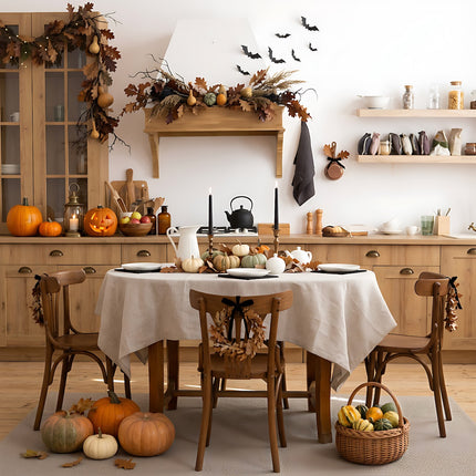 Natural beige linen tablecloth on a dining table in a Halloween kitchen with pumpkins, black candles and bat decorations – CoolLinen