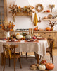Terracotta linen placemats and napkins on a Thanksgiving dinner table with a natural linen tablecloth, pumpkins and candles – CoolLinen