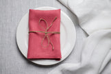 Salmon organic linen napkin arranged for Easter dinner table decor. The warm pink tone adds romantic spring energy to holiday entertaining. Crafted from premium natural linen for sustainable and reusable table styling.