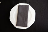 Slate linen dinner napkin with neatly sewn mitered corners.