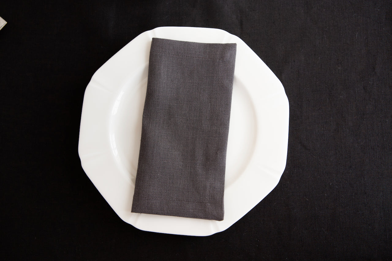 Slate linen dinner napkin with neatly sewn mitered corners.