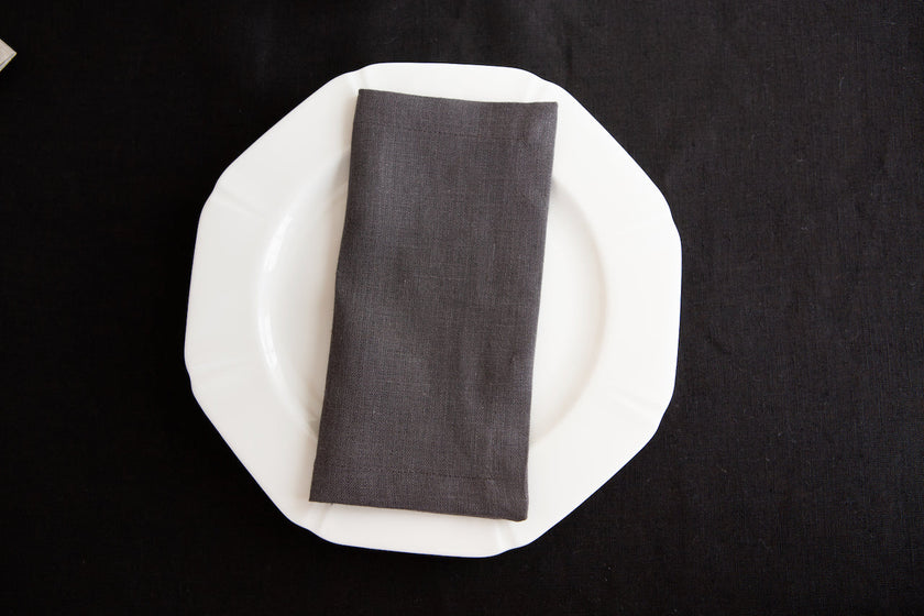 Slate linen dinner napkin with neatly sewn mitered corners.