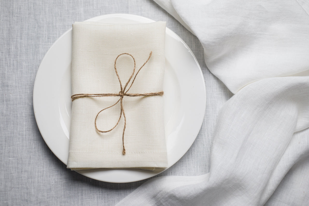 White organic linen napkin styled for minimal Easter table setting. The natural texture highlights spring simplicity and elegant holiday decor. Sustainable linen textile designed for reusable and timeless entertaining.