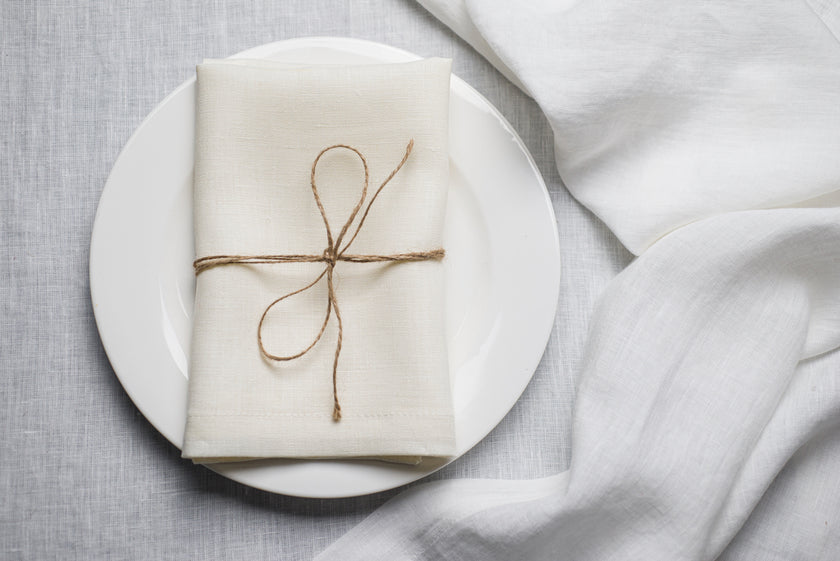 White organic linen napkin styled for minimal Easter table setting. The natural texture highlights spring simplicity and elegant holiday decor. Sustainable linen textile designed for reusable and timeless entertaining.