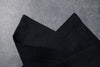 Black linen fabric close-up with mitered hem corner – CoolLinen color 1. Black