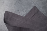 Grey linen fabric close-up with mitered hem corner – CoolLinen color 3. Grey