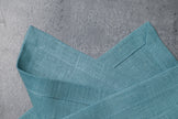 Teal linen fabric close-up with mitered hem corner – CoolLinen color Teal