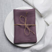 Fog linen napkin tied with jute twine on a white plate