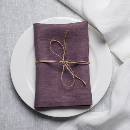 Fog linen napkin tied with jute twine on a white plate