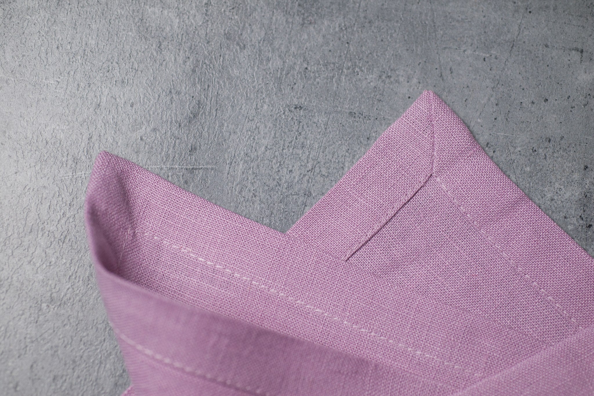 Lavender linen fabric close-up with mitered hem corner – CoolLinen color 19. Lavender