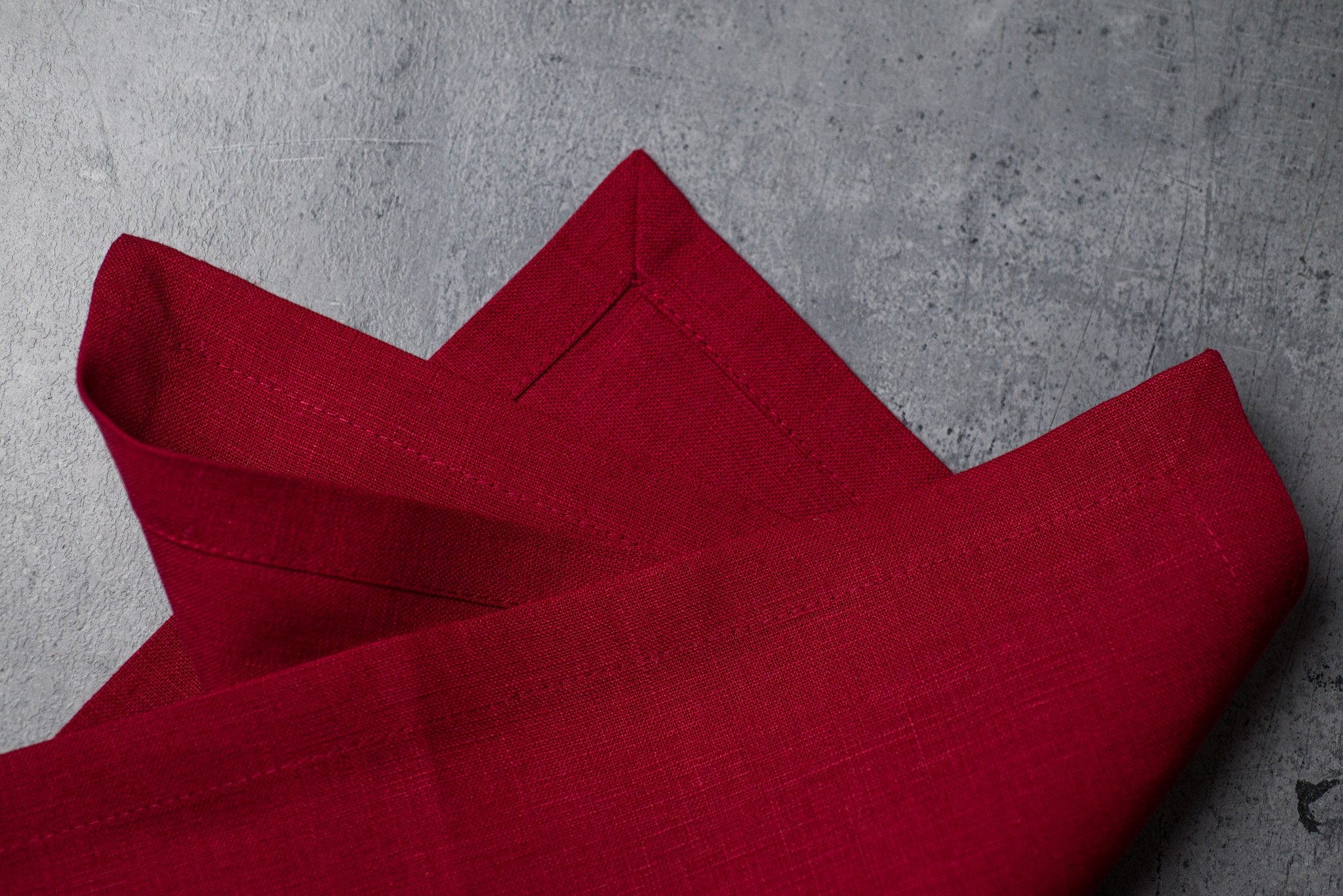Wine linen fabric close-up with mitered hem corner – CoolLinen color 25. Wine
