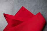 Red linen fabric close-up with mitered hem corner – CoolLinen color 27. Red