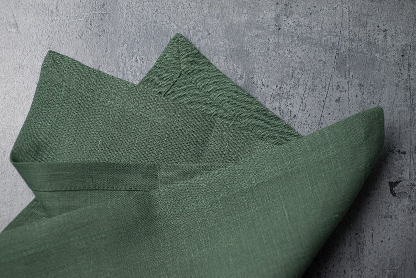 Sage linen fabric close-up with mitered hem corner – CoolLinen color 31. Sage