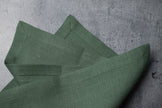 Sage linen fabric close-up with mitered hem corner – CoolLinen color 31. Sage