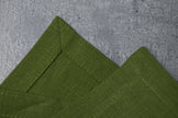 Green linen fabric close-up with mitered hem corner – CoolLinen color 32. Green