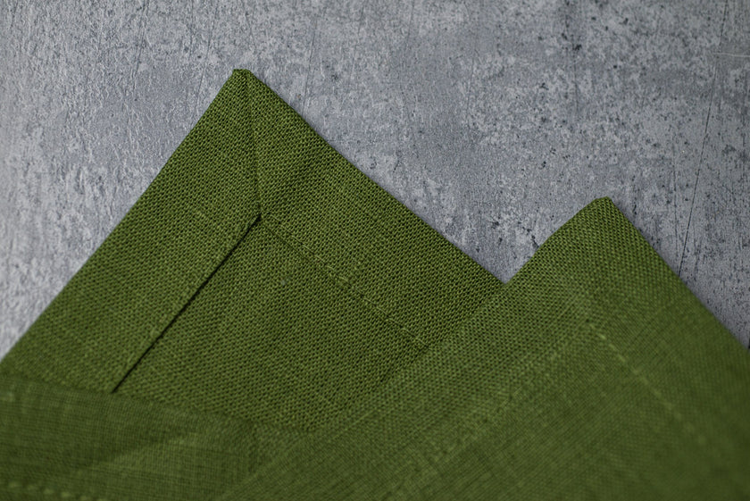 Green linen fabric close-up with mitered hem corner – CoolLinen color 32. Green