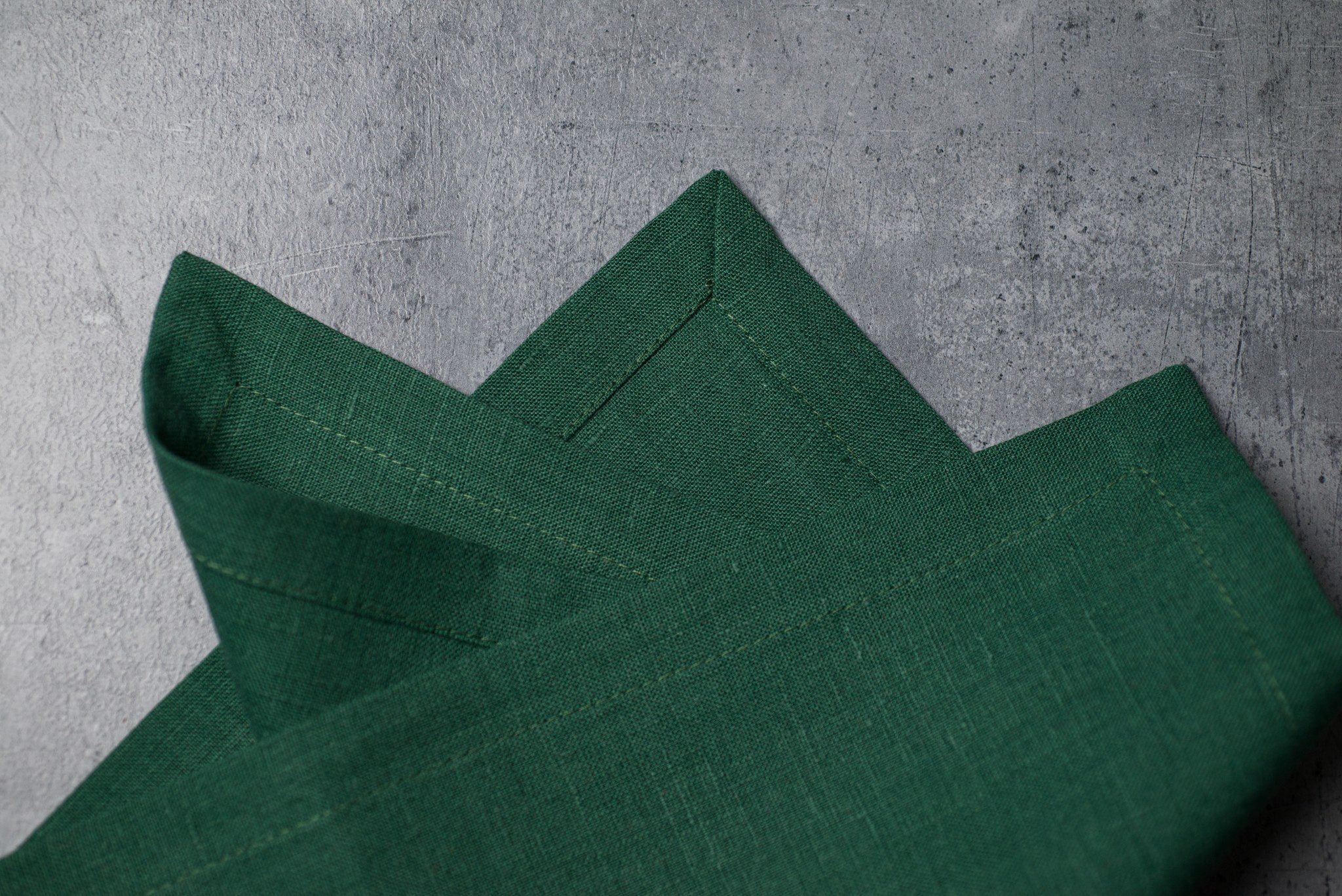 Hunter linen fabric close-up with mitered hem corner – CoolLinen color 33. Hunter