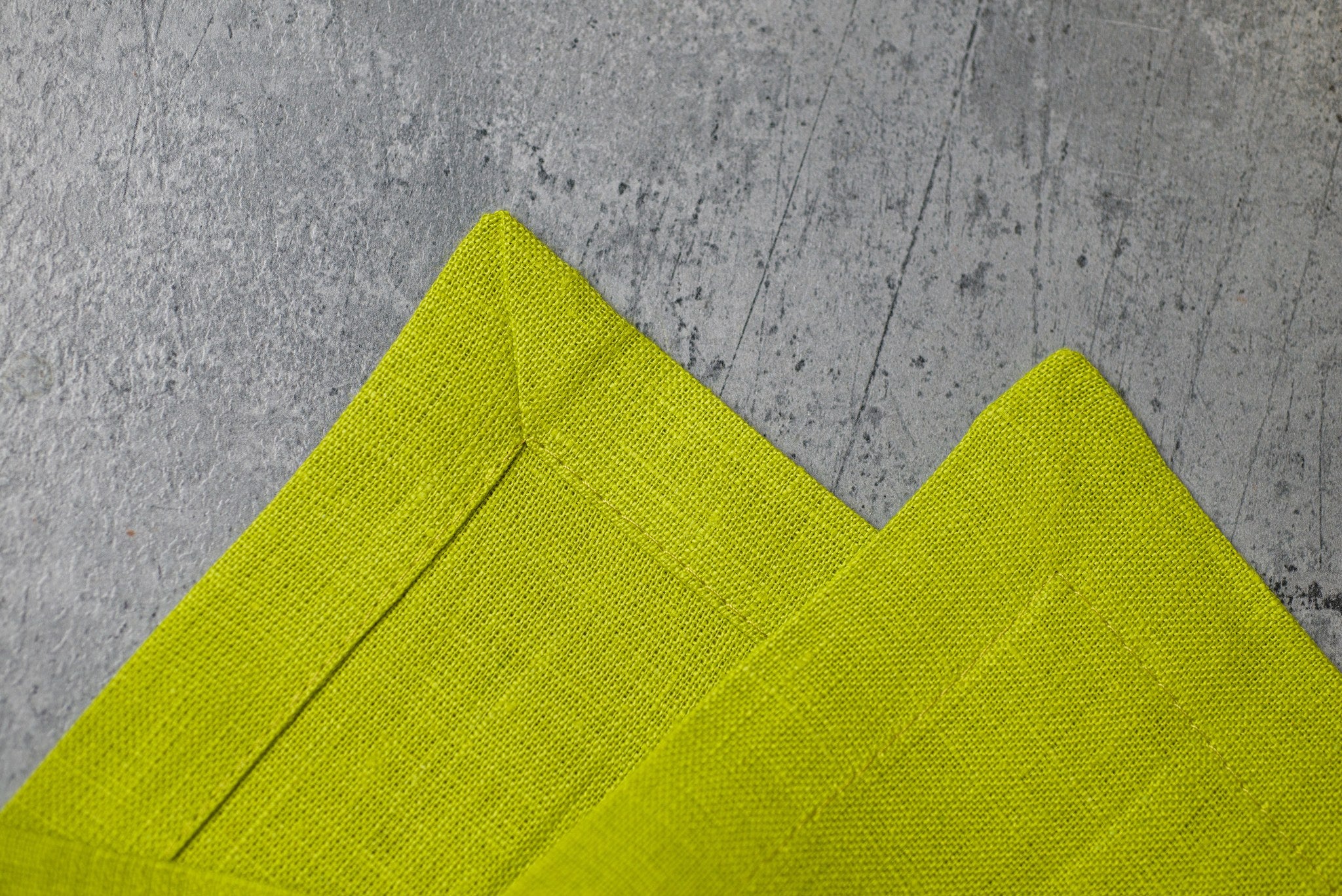 Lime linen fabric close-up with mitered hem corner – CoolLinen color 34. Lime