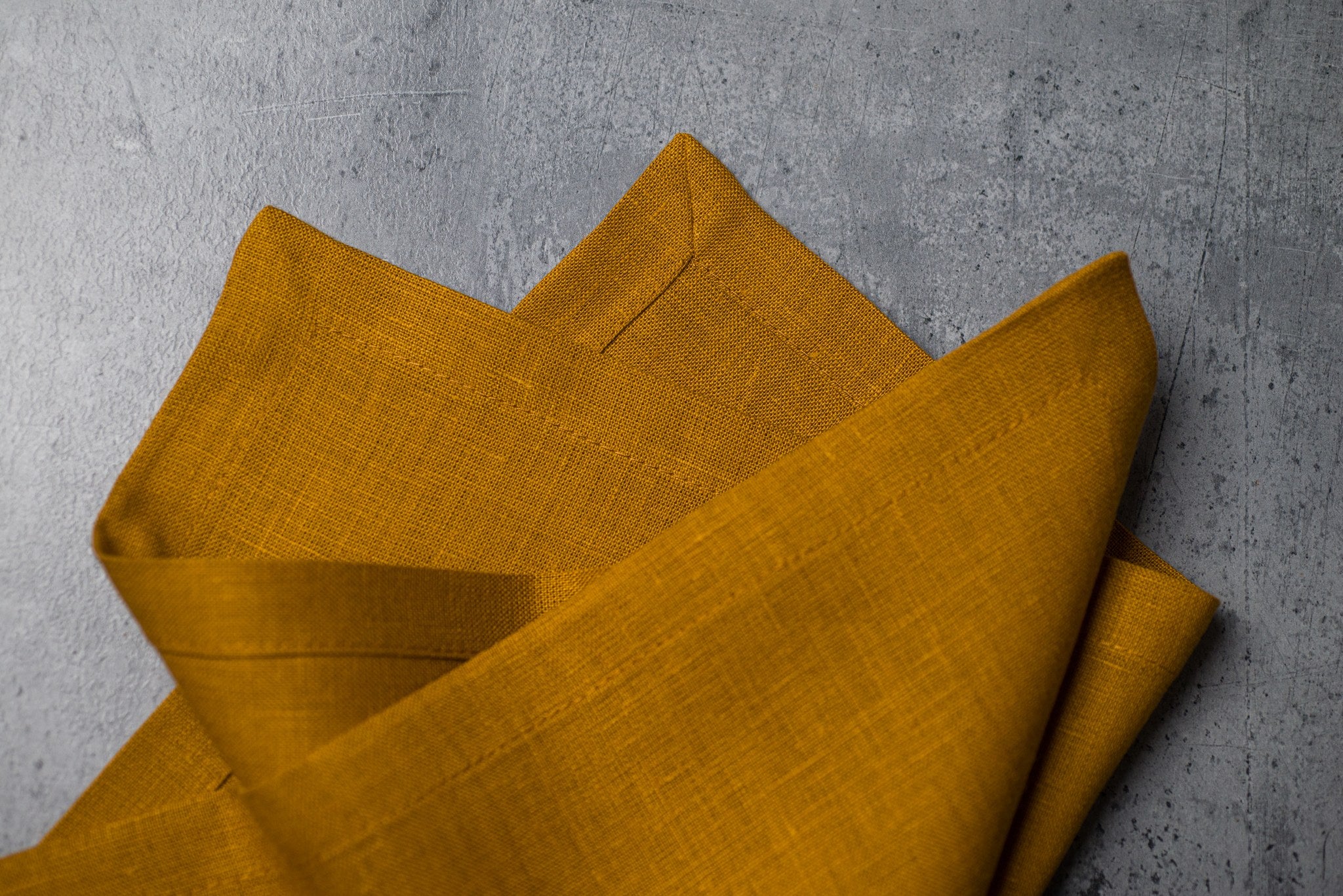 Dijon linen fabric close-up with mitered hem corner – CoolLinen color 40. Dijon