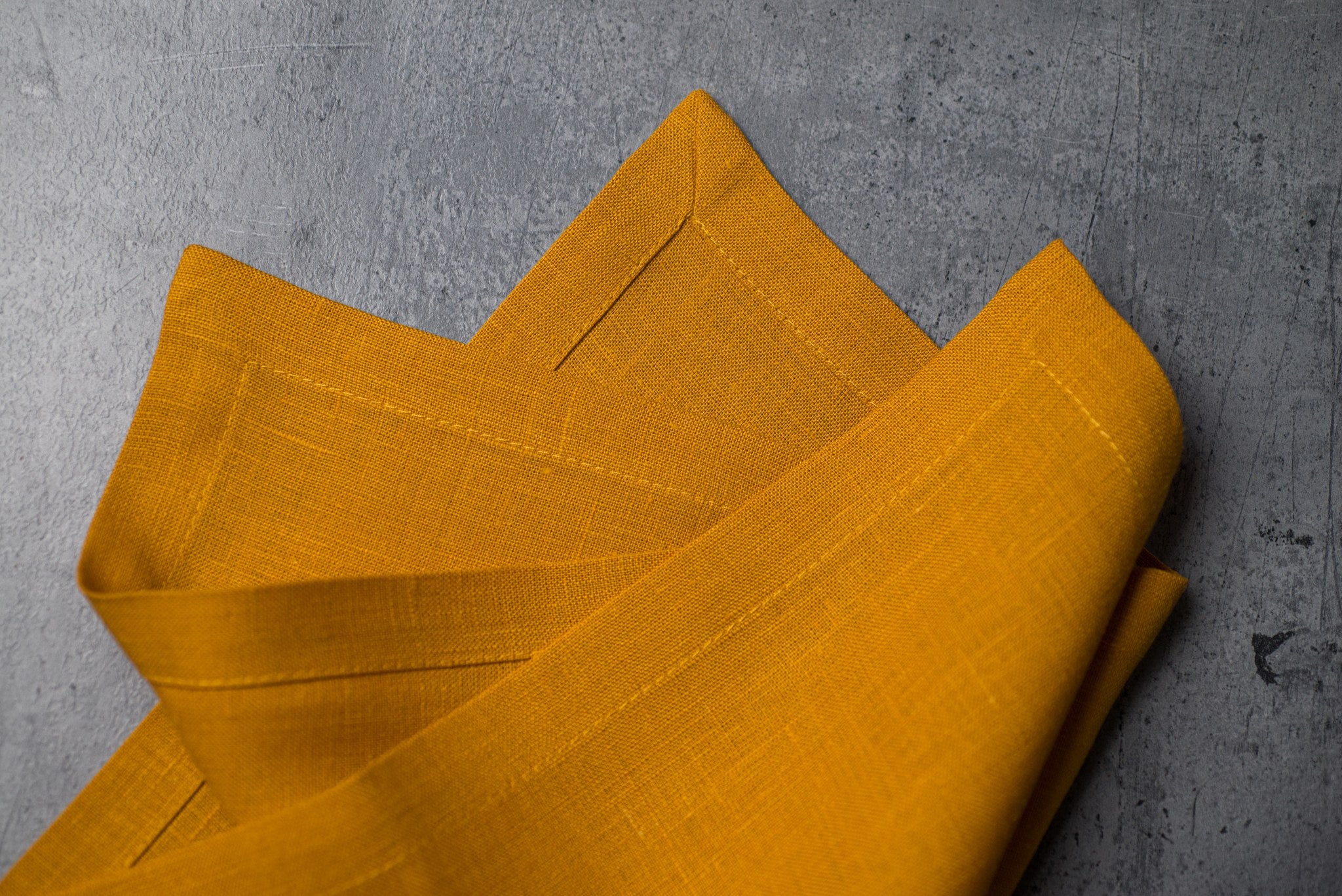 Canary linen fabric close-up with mitered hem corner – CoolLinen color 42. Canary