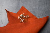 Terracotta linen fabric close-up with mitered hem corner – CoolLinen color 43. Terracotta
