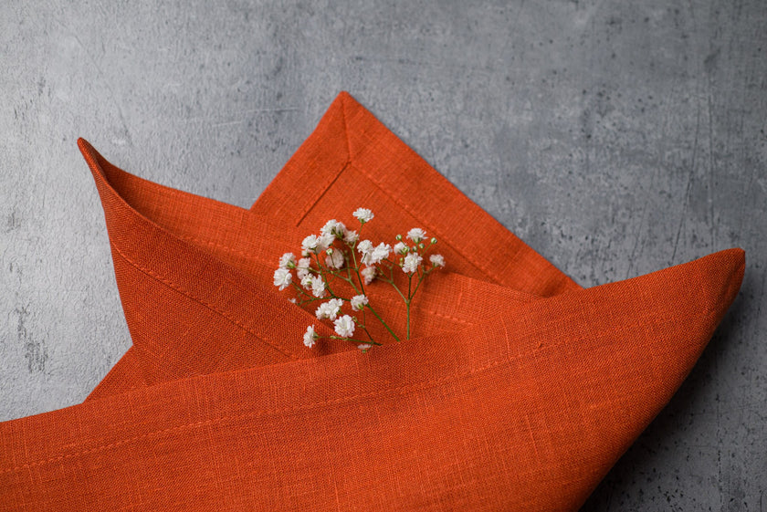 Terracotta linen fabric close-up with mitered hem corner – CoolLinen color 43. Terracotta